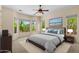 Inviting bedroom with bay windows providing natural light and views of the lush exterior at 4528 E Donato Dr, Gilbert, AZ 85298