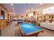 Inviting billiard room with pool tables and ample seating, perfect for leisure and entertainment at 4528 E Donato Dr, Gilbert, AZ 85298
