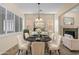 Elegant dining room with a marble table, seating for six, and stylish decor at 4528 E Donato Dr, Gilbert, AZ 85298
