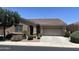 Charming single-story home with a well-manicured front yard and a two-car garage at 4528 E Donato Dr, Gilbert, AZ 85298