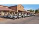 Row of golf carts parked outside the clubhouse, offering a convenient and accessible golfing experience at 4528 E Donato Dr, Gilbert, AZ 85298