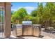 Built-in stainless steel BBQ with counter space is perfect for outdoor entertaining at 4528 E Donato Dr, Gilbert, AZ 85298