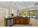 Open kitchen with breakfast bar overlooking the living area and a covered patio at 4528 E Donato Dr, Gilbert, AZ 85298