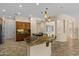 Open-concept kitchen with granite counters, a breakfast bar, and modern lighting fixtures at 4528 E Donato Dr, Gilbert, AZ 85298