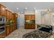 Gourmet kitchen with custom cabinetry, granite countertops, and stainless steel appliances at 4528 E Donato Dr, Gilbert, AZ 85298