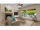 Bright and airy living room featuring a fireplace, large windows, and comfortable seating at 4528 E Donato Dr, Gilbert, AZ 85298