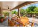 Outdoor patio featuring dining area, seating area, and lush landscaping, perfect for outdoor gatherings at 4528 E Donato Dr, Gilbert, AZ 85298