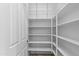 Walk-in pantry with ample shelving for organized storage of food items and household supplies at 4528 E Donato Dr, Gilbert, AZ 85298