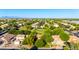 Scenic aerial view of a residential neighborhood with mature trees, green spaces, and mountain views at 5139 S Marble St, Gilbert, AZ 85298