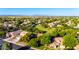 Aerial view of a residential community with lush green spaces and mountain views in the distance at 5139 S Marble St, Gilbert, AZ 85298