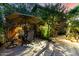 Backyard patio area with built-in steps, dining table with umbrella, and cozy string lights at 5139 S Marble St, Gilbert, AZ 85298