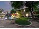 Spacious backyard with a pool, manicured lawn, mature trees, and cozy lounge areas at 5139 S Marble St, Gilbert, AZ 85298