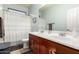 Bathroom with a double-sink vanity, a framed mirror, and a shower-tub combination at 5139 S Marble St, Gilbert, AZ 85298