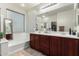 A well-lit bathroom boasts double sinks and a soaking tub, perfect for unwinding at 5139 S Marble St, Gilbert, AZ 85298