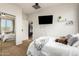 A comfy bedroom with a queen bed, soft brown carpet, and a convenient mirrored closet at 5139 S Marble St, Gilbert, AZ 85298