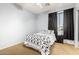 Cozy bedroom featuring a queen bed, black-out curtains, and neutral carpet at 5139 S Marble St, Gilbert, AZ 85298