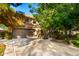 Charming home featuring a tile roof, two-car garage, mature trees, and a basketball hoop on a sunny day at 5139 S Marble St, Gilbert, AZ 85298