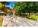 Charming home featuring a tile roof, two-car garage, mature trees, and a basketball hoop on a sunny day at 5139 S Marble St, Gilbert, AZ 85298