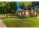 Charming home with tile roof, arched windows, lush green lawn and mature trees at 5139 S Marble St, Gilbert, AZ 85298