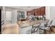Kitchen with granite countertops, rich wood cabinets and breakfast bar seating at 5139 S Marble St, Gilbert, AZ 85298
