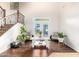 Bright living room features high ceilings, stairs, hardwood floors, and french doors to the backyard at 5139 S Marble St, Gilbert, AZ 85298