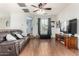 Comfortable living room featuring hardwood floors, ceiling fan, and lots of natural light at 5139 S Marble St, Gilbert, AZ 85298