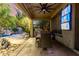 Covered patio with a dining table, TV, ceiling fan, and beautiful landscaping at 5139 S Marble St, Gilbert, AZ 85298