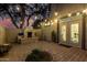 Charming backyard patio features a brick surface, fireplace, and ambient string lights at 5139 S Marble St, Gilbert, AZ 85298