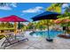 Backyard oasis featuring a sparkling pool, rock waterfall, lush landscaping, and lounge chairs at 5139 S Marble St, Gilbert, AZ 85298