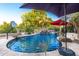 Sparkling pool surrounded by lush landscaping and rock features with a waterfall and lounge chairs at 5139 S Marble St, Gilbert, AZ 85298