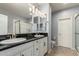 Bright bathroom features a double sink vanity with sleek countertops, and a glass-enclosed shower at 5550 N 16Th St # 166, Phoenix, AZ 85016