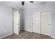 This bedroom features gray walls, wood-look floors, closet with sliding doors, and natural light at 5550 N 16Th St # 166, Phoenix, AZ 85016