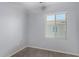 Bright bedroom with light gray walls, light baseboards, one window, and wood-look flooring at 5550 N 16Th St # 166, Phoenix, AZ 85016