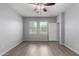 Well-lit bedroom with modern ceiling fan and hardwood floors, showcasing bright windows at 5550 N 16Th St # 166, Phoenix, AZ 85016