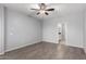 Neutral bedroom features a ceiling fan and light gray walls and luxury vinyl plank flooring at 5550 N 16Th St # 166, Phoenix, AZ 85016