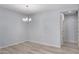Dining room showcasing wood-look floors, modern chandelier, and neutral paint scheme at 5550 N 16Th St # 166, Phoenix, AZ 85016