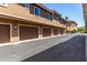 Building with attached garages, modern lighting, and spacious parking in community at 5550 N 16Th St # 166, Phoenix, AZ 85016