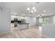 Open-concept kitchen with an island, modern pendant lighting, and stainless steel appliances at 5550 N 16Th St # 166, Phoenix, AZ 85016