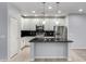 Modern kitchen with stainless steel appliances, a kitchen island, and white cabinetry at 5550 N 16Th St # 166, Phoenix, AZ 85016