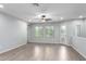 Bright living room featuring wood-look floors, a ceiling fan, and plenty of natural light at 5550 N 16Th St # 166, Phoenix, AZ 85016