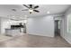 Bright living room showcasing wood-look floors, an open floorplan, and access to the kitchen at 5550 N 16Th St # 166, Phoenix, AZ 85016