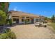 A covered back patio with patterned concrete, a stone picnic table, and desert landscaping at 592 W Harvard Ave, Gilbert, AZ 85233