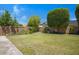 Well-maintained backyard with lush lawn and a stone planter area along the back fence at 592 W Harvard Ave, Gilbert, AZ 85233