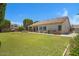 Large backyard with a lush lawn and a stone picnic table and the back of the house at 592 W Harvard Ave, Gilbert, AZ 85233