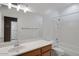 Bright bathroom features a large vanity, a soaking tub with shower, and a view into the kitchen at 592 W Harvard Ave, Gilbert, AZ 85233
