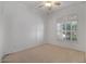 Bright bedroom features a neutral carpet, ceiling fan, and a shuttered window that allows natural light to fill the room at 592 W Harvard Ave, Gilbert, AZ 85233