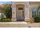 Close-up of the front door with an arched entryway, decorative plants, and well-maintained desert landscaping at 592 W Harvard Ave, Gilbert, AZ 85233