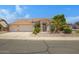 Charming single-story home featuring a spacious garage, desert landscaping, and a welcoming entrance at 592 W Harvard Ave, Gilbert, AZ 85233