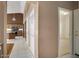 Inviting hallway leading to the kitchen features tiled floors, neutral walls, and a bank of storage closets at 592 W Harvard Ave, Gilbert, AZ 85233