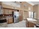 Kitchen with stainless appliances, tile floors, granite counters, and custom cabinetry at 592 W Harvard Ave, Gilbert, AZ 85233